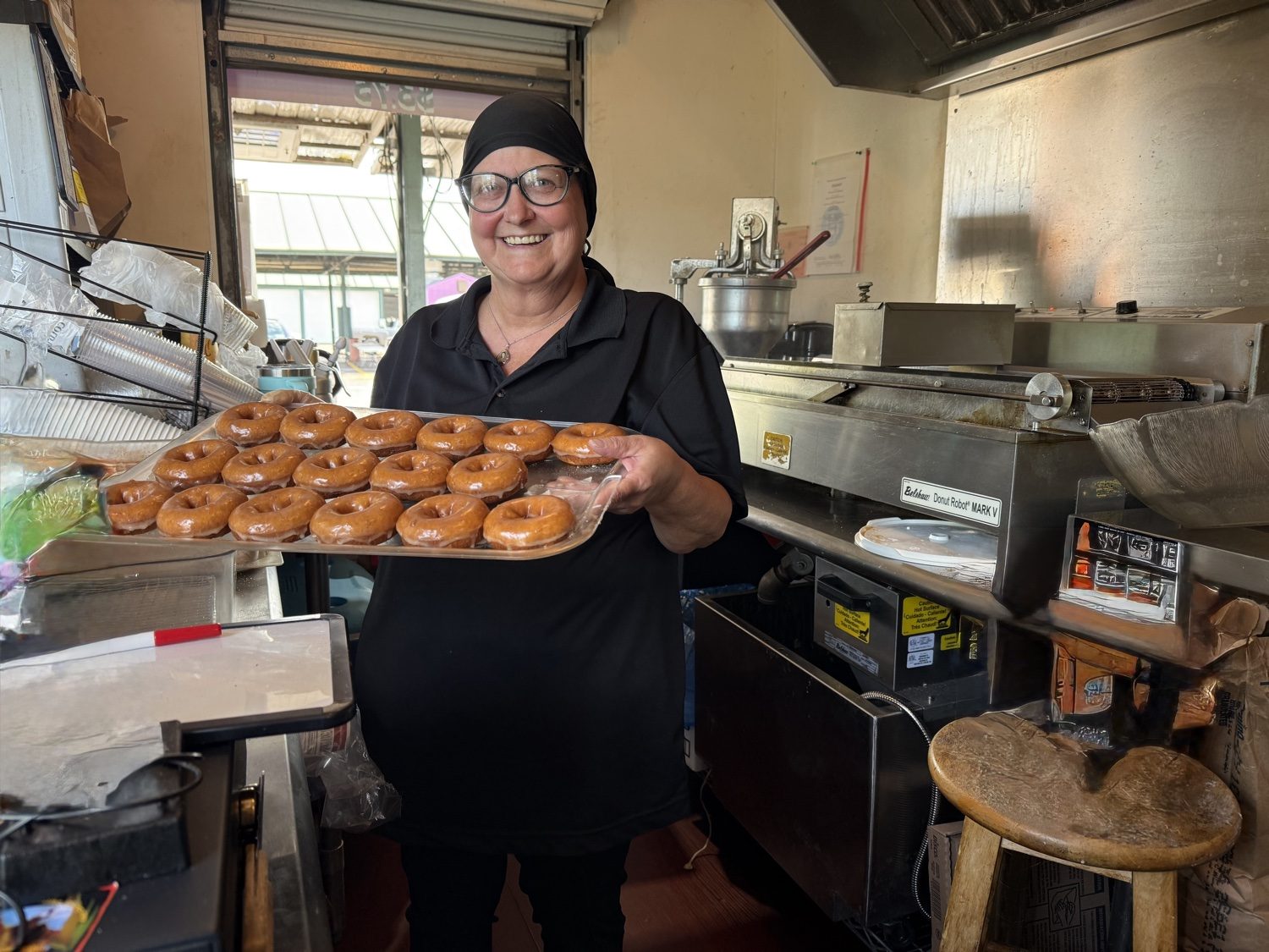 A tray of fresh glazed donuts